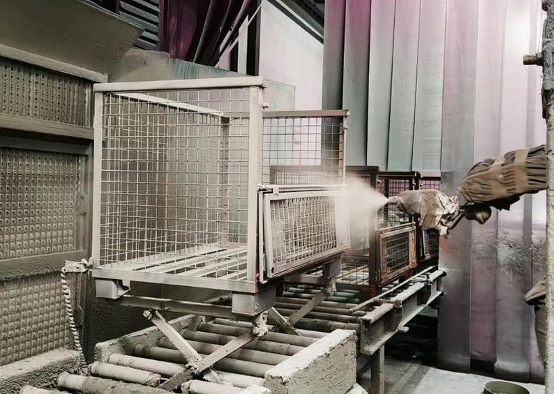 Container in the powder coating booth